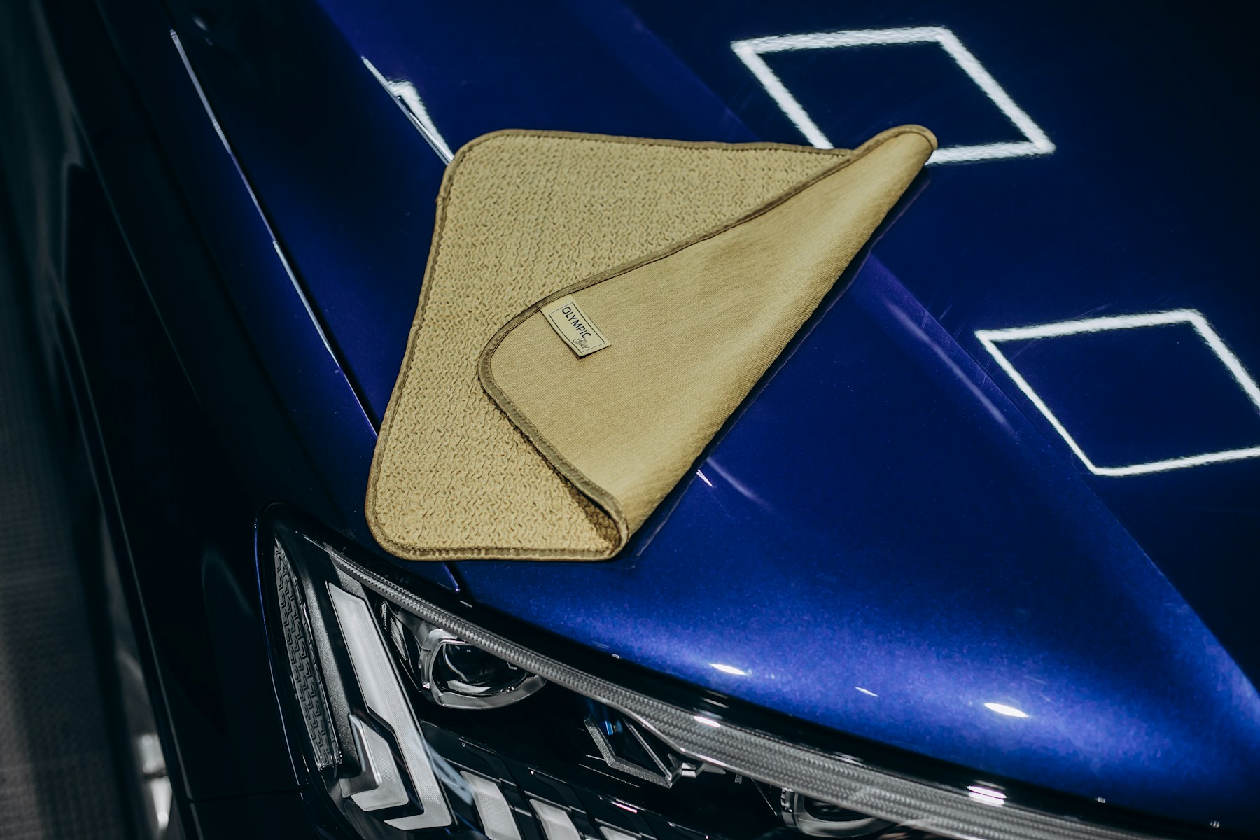 Microfiber cloth on a freshly cleaned blue car finish